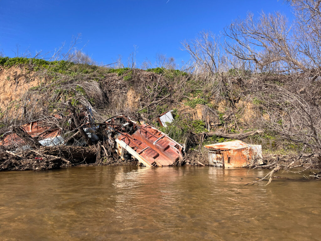 More abandoned cars and appliances on the riverbank