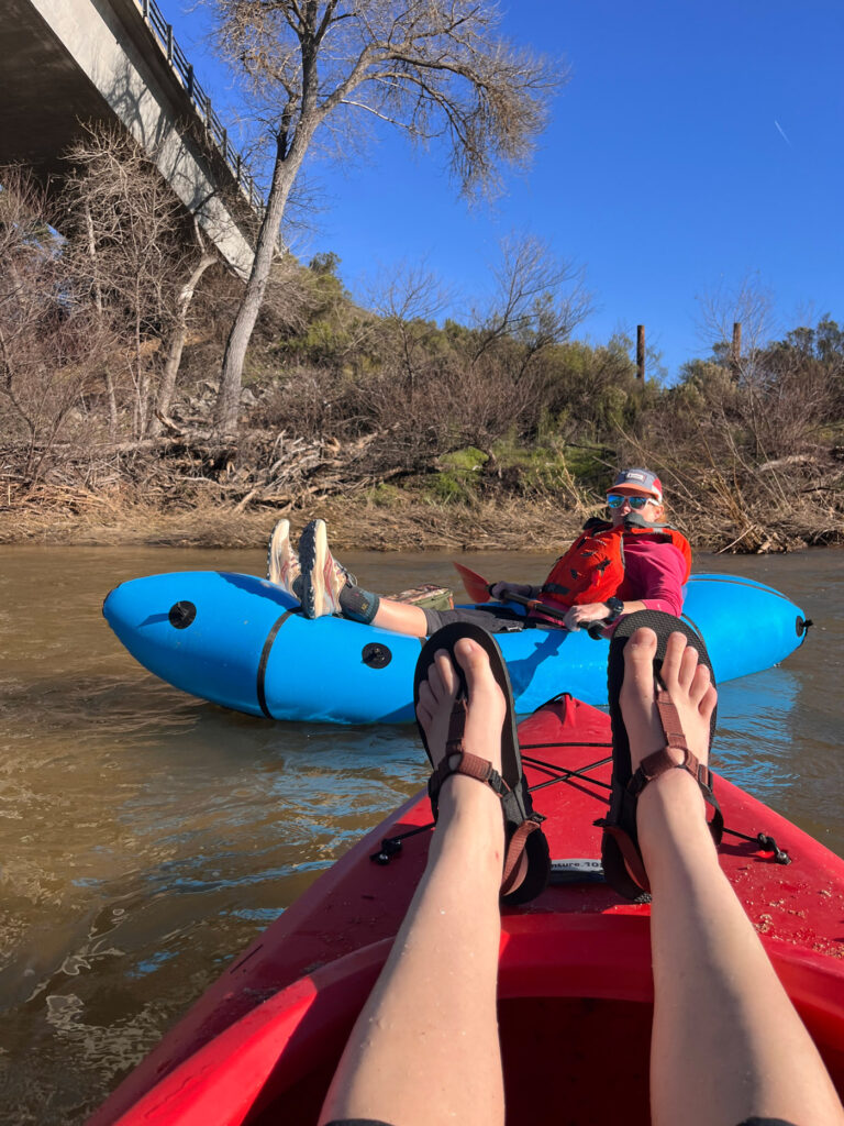 Close-up view of person in a packraft on the river.